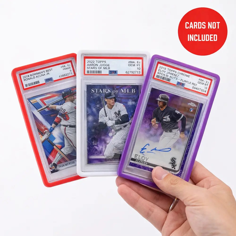Hand holding three PSA graded sports cards protected by red, white, and purple silicone slab bumper guards for shockproof TCG storage.