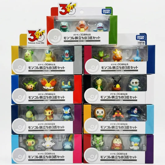 Set of six small toy figures in packaging with colorful bases on a white background