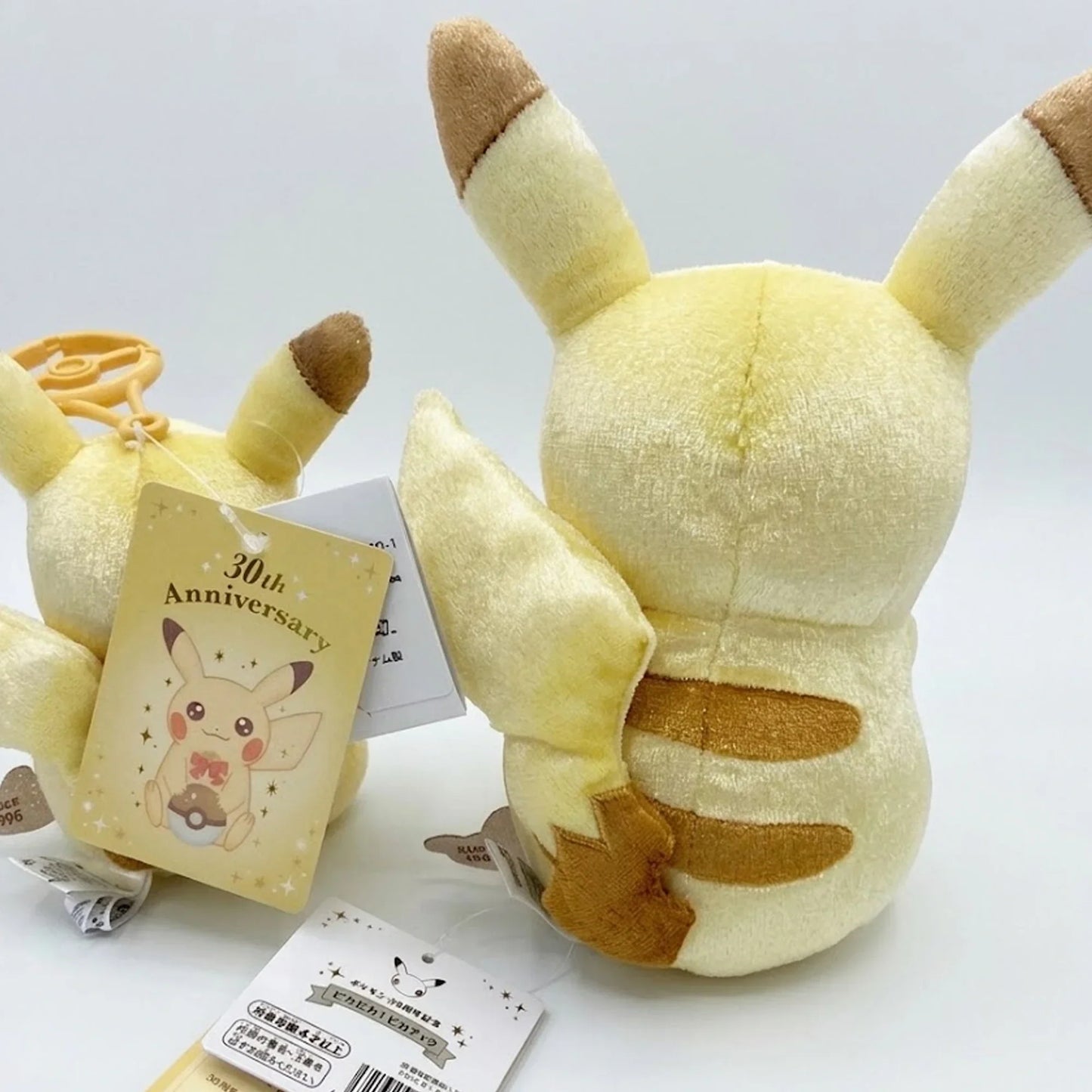 Plush toy with a 30th anniversary tag on a white background