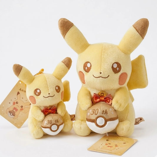 Two Pikachu plush toys with '30th' on their bellies on a white background