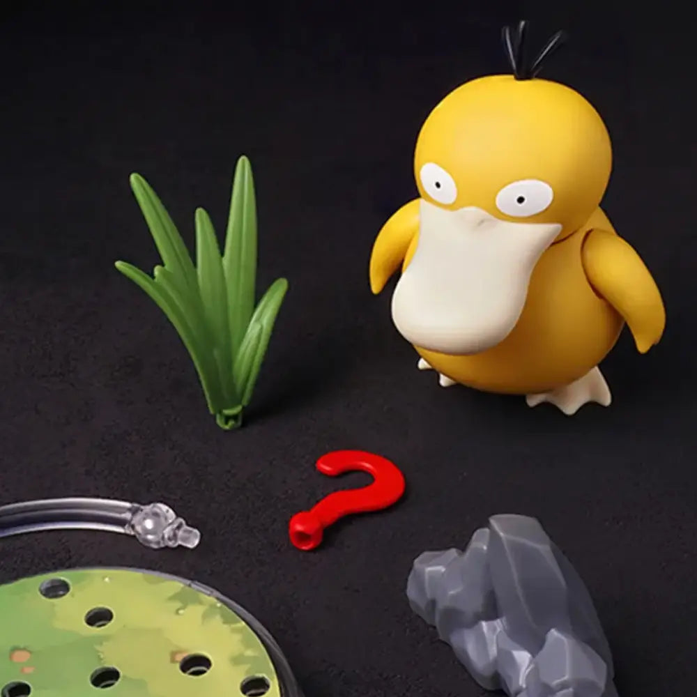 Yellow and white cartoon-like creature with a green plant, red question mark, and gray object on a dark background